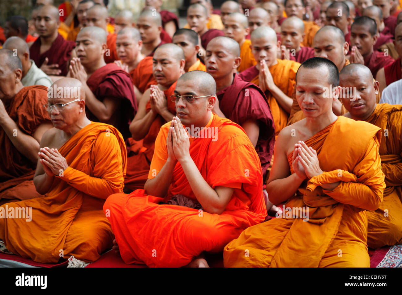 International Buddhist monks pray at Mahabodhi temple, Bodh Gaya, India, a day after terrorism bomb blast on 7 July 2013. Stock Photo
