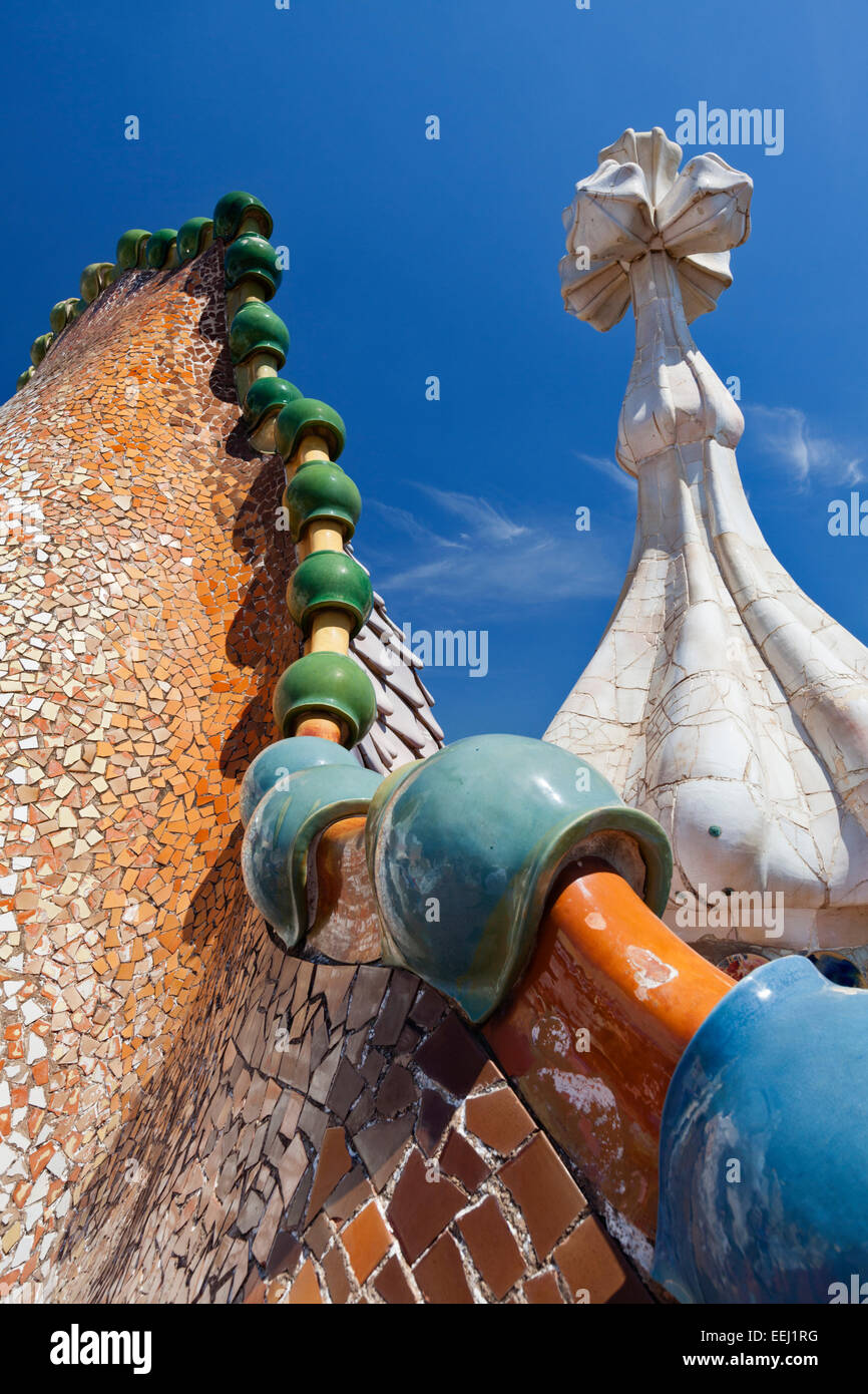 Colourful ceramic and glass pieces form a dragon's back sculpture on the roof of Casa Batllo House in Barcelona, Spain. Stock Photo