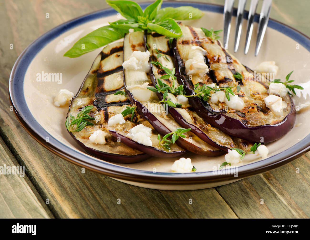 Grilled eggplant slices on a plate. Selective focus Stock Photo