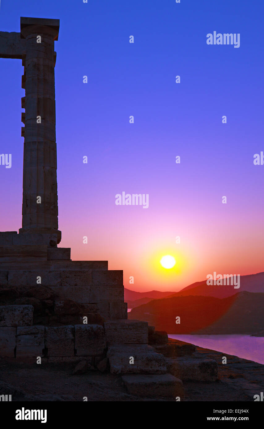 Sun setting at the Temple of Poseidon at Cape Sounion in Greece Stock Photo