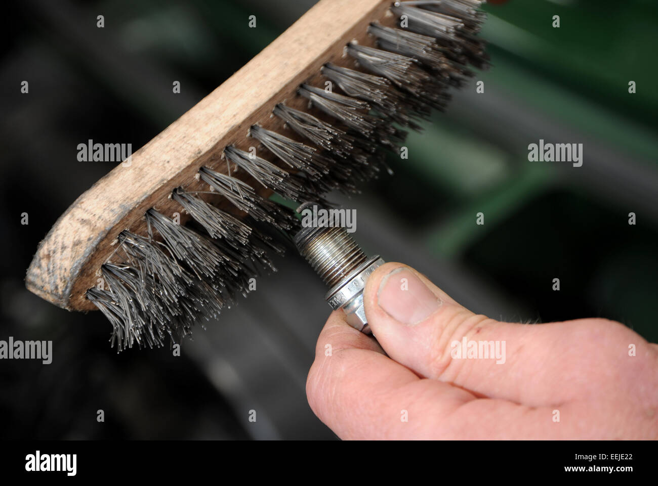 How To Clean Spark Plugs >> Cleaning A Car Engine Spark Plug With A Wire Brush Stock Photo How To Clean Spark Plugs >> Cleaning A Car Engine Spark Plug With A Wire Brush Stock Photo