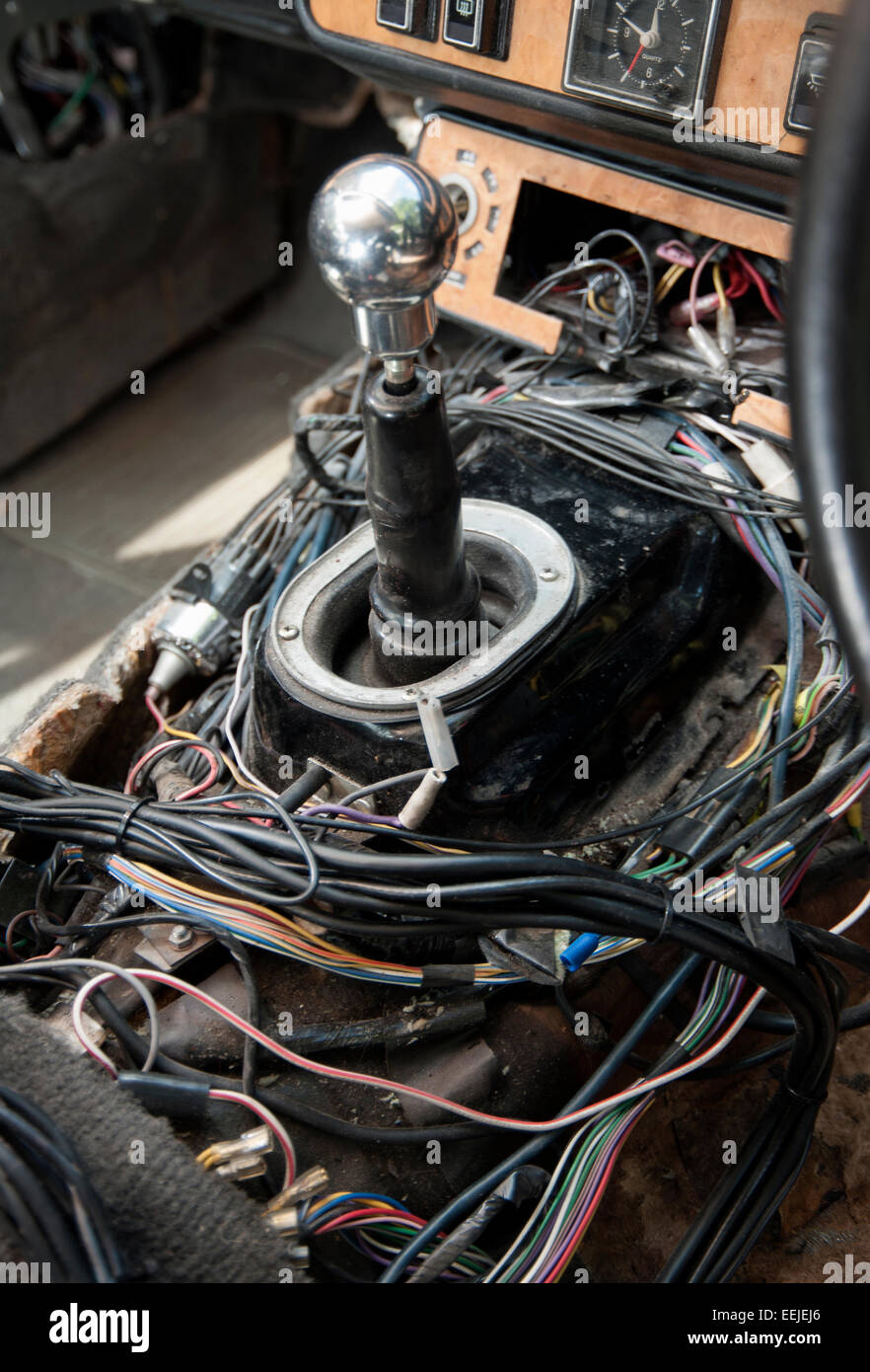 confusing tangle or wires revealed when the trim is removed from a modern car Stock Photo