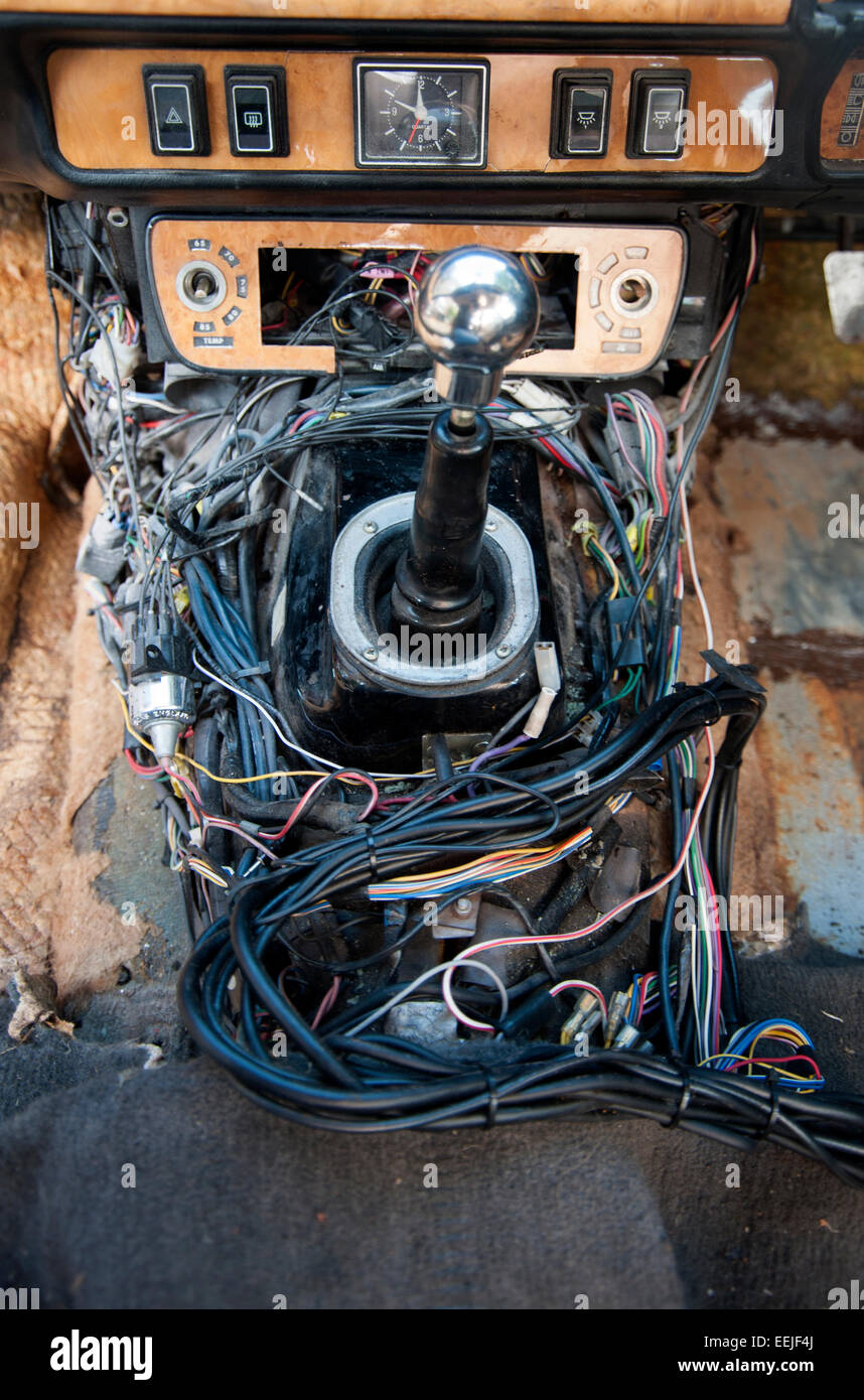 confusing tangle or wires revealed when the trim is removed from a modern car Stock Photo