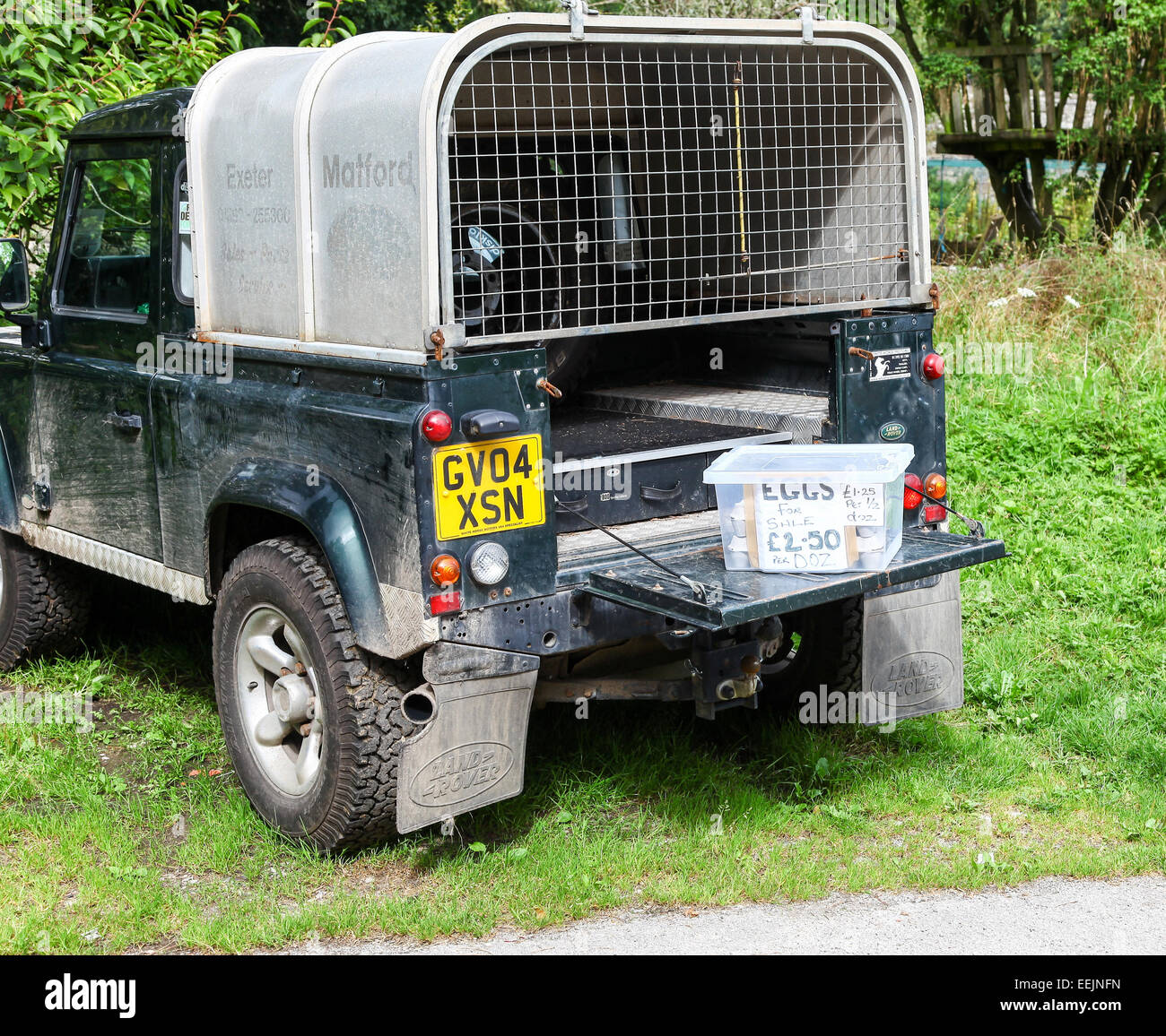 Eggs for sale with a honesty box for people to put their money in when they buy the eggs in the back of a Land Rover Stock Photo