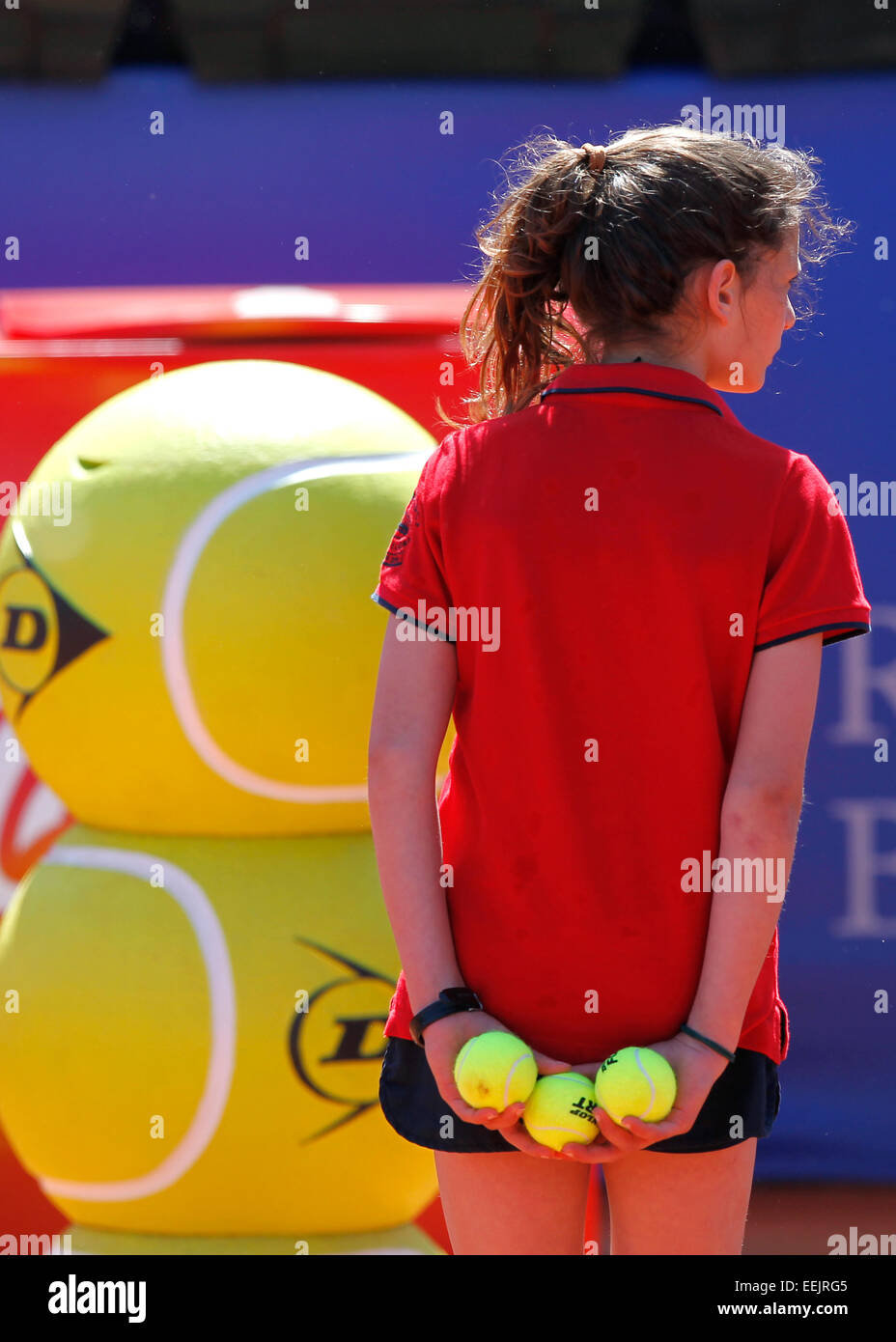 Ball girl holding tennis balls during a clay court tennis match Stock Photo