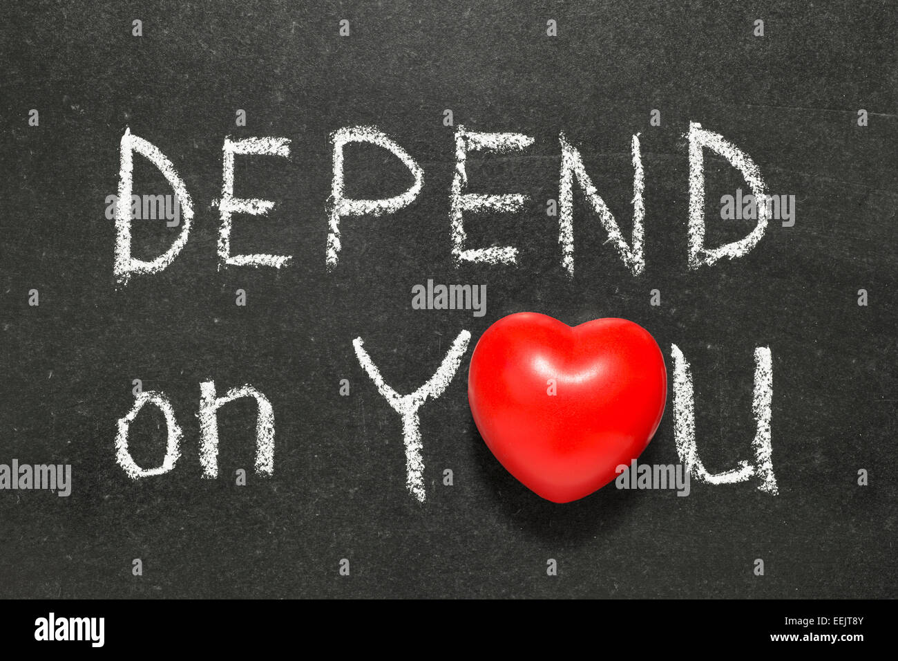 depend on you phrase phrase handwritten on blackboard with heart symbol instead of O Stock Photo