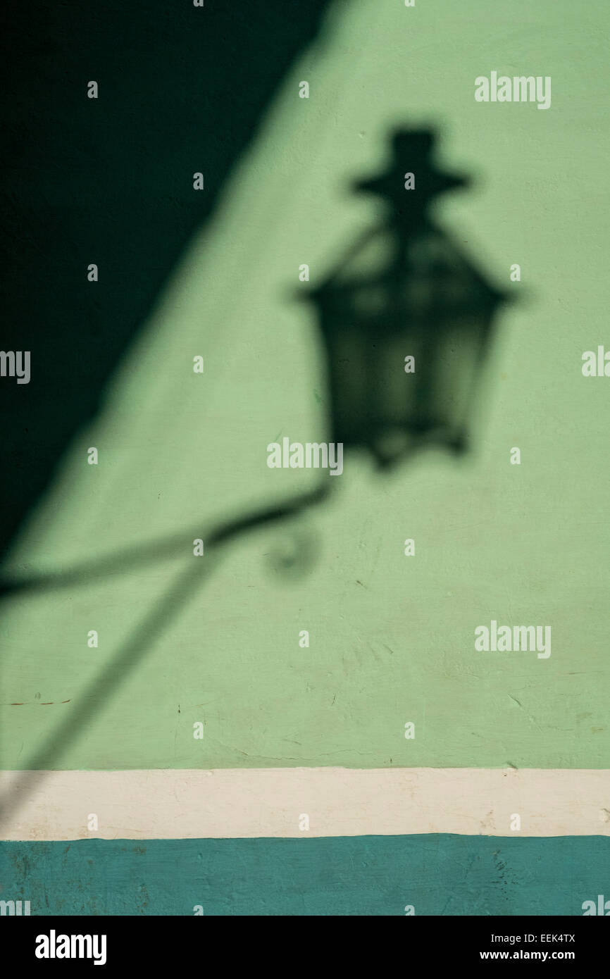 Soft shadow outline of a wall lamp in the sunlight. Stock Photo