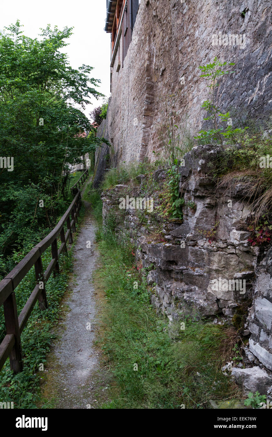 small path with wooden handrail and historic wall Stock Photo