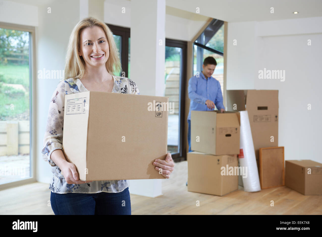 Young Couple Moving Into New Home Together Stock Photo