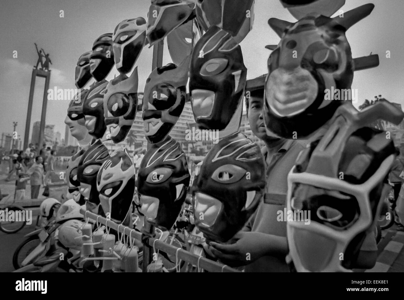 Fictional figure masks street vendor near Selamat Datang (Welcome) Monument in Thamrin Street, Jakarta. Stock Photo