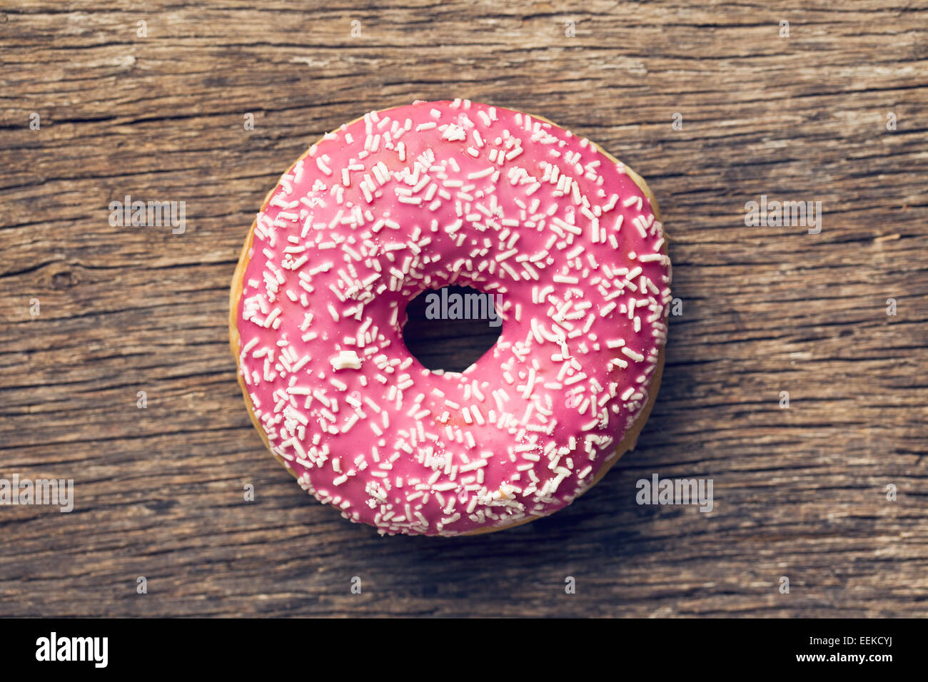 pink donut on old wooden background Stock Photo
