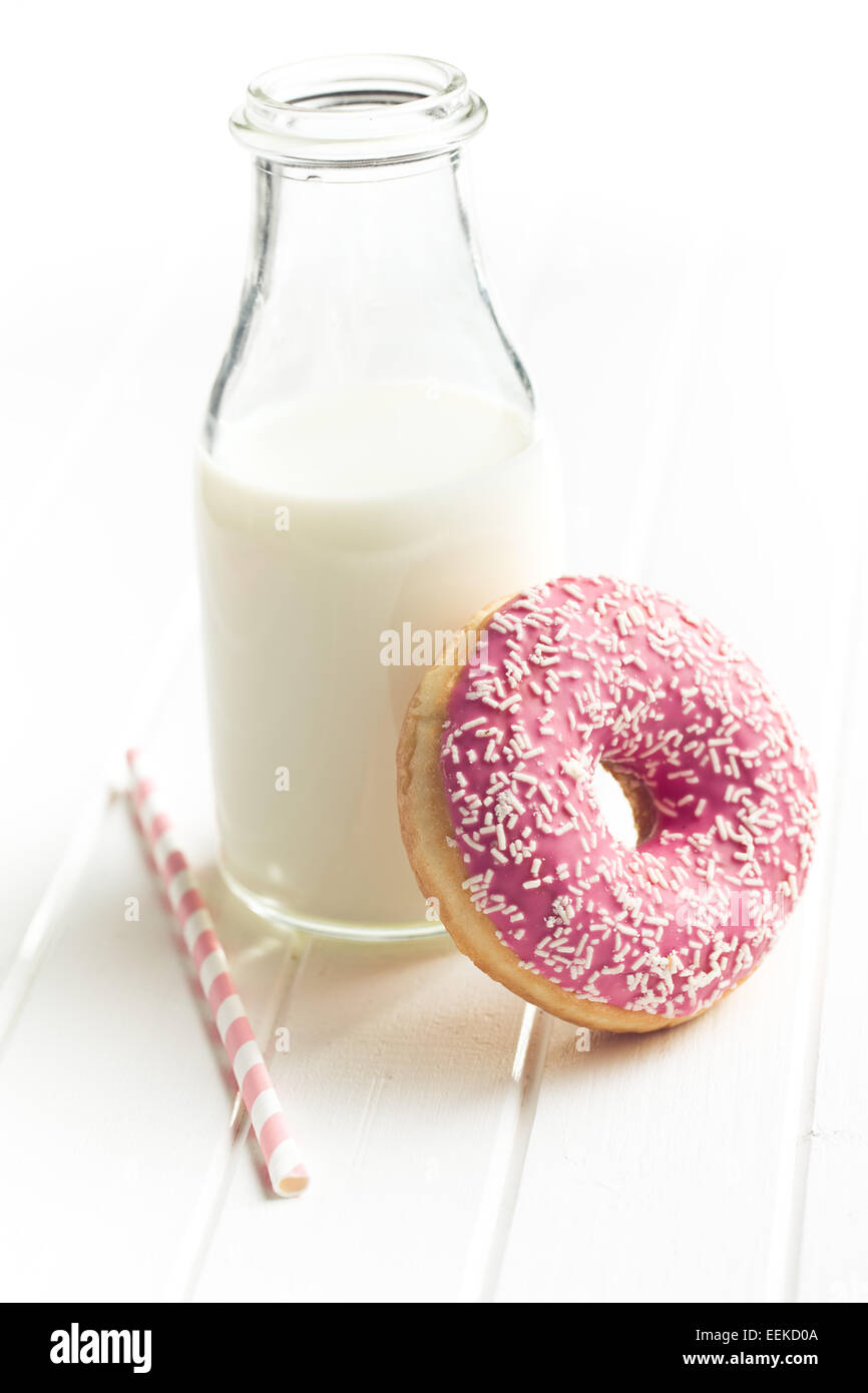 pink donut and milk on kitchen table Stock Photo Alamy