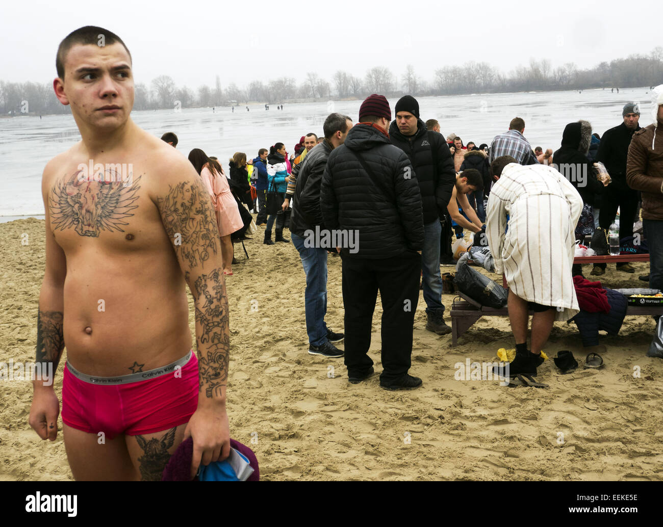 Jan. 19, 2015 - Young man in a bathing suit-clad cost among believers on the banks of the Dnieper. -- 19 January, 2015, Kiev, Ukraine, great Christian holiday Epiphany. One of the main traditions of celebration is swimming in Jordan (the so-called consecrated priest hole). The current winter was unusually mild in Ukraine and swimming just held on the beach. Ukrainian Church of the Moscow Patriarchate traditionally celebrated in Obolon. © Igor Golovniov/ZUMA Wire/Alamy Live News Stock Photo