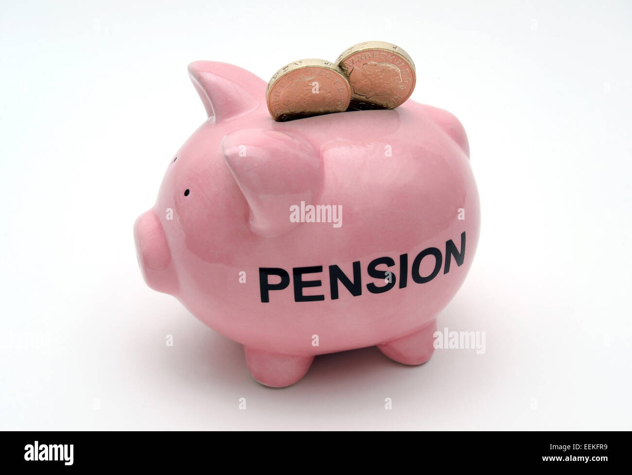 PIGGYBANK WITH POUND COINS AND PENSION WORD RE PRICES COSTS HOUSEHOLD BUDGETS PENSION ANNUITY COMPANY SAVINGS RETIREMENT UK Stock Photo