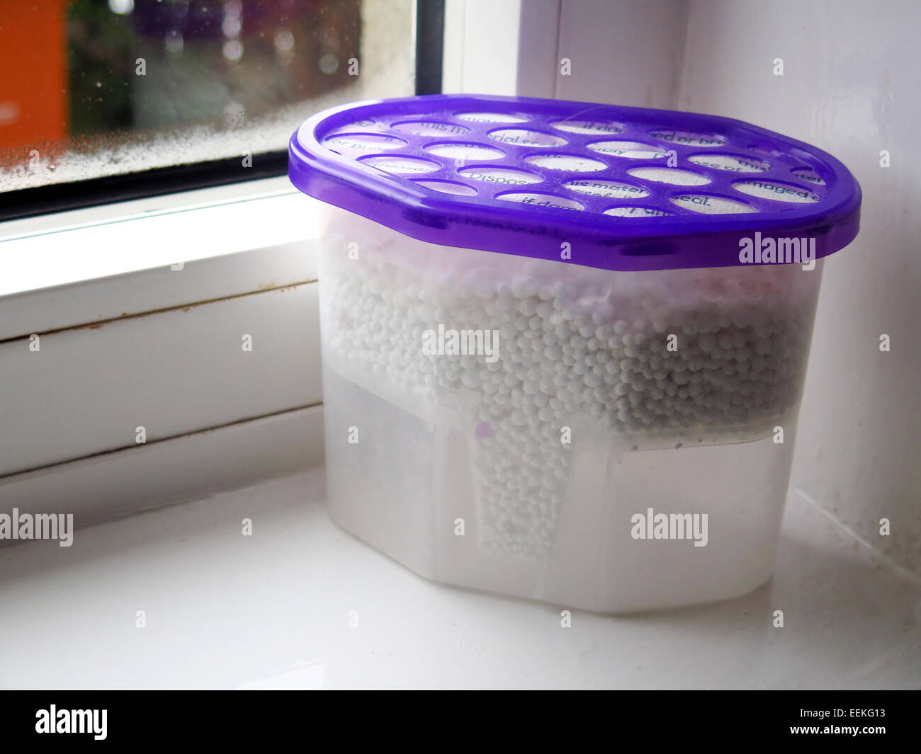 Disposable de-humidifiers on window sill Stock Photo - Alamy