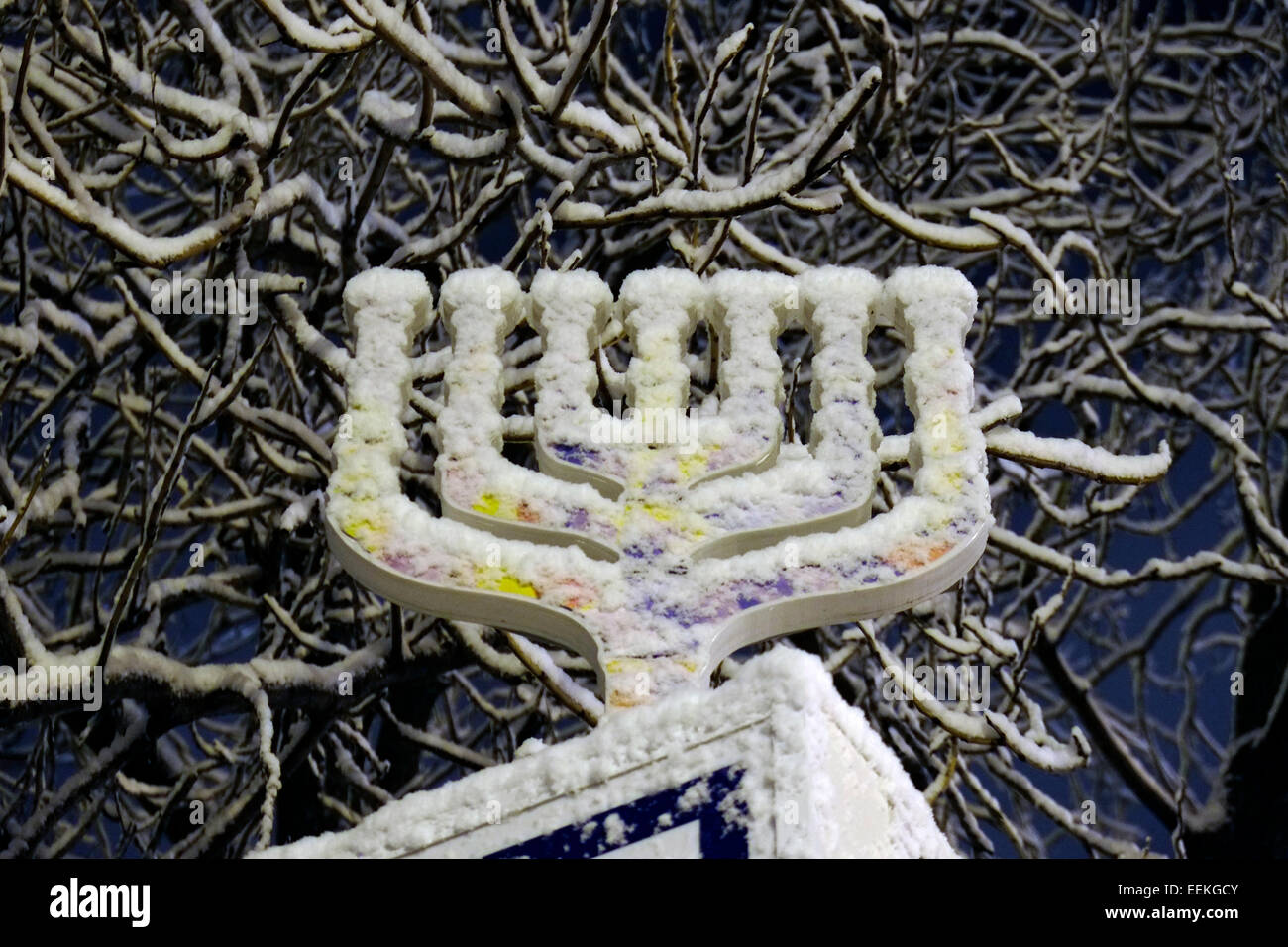 The Menorah, a seven branched candelabra one of the symbols of Judaism since ancient times covered with snow in Jerusalem Israel Stock Photo