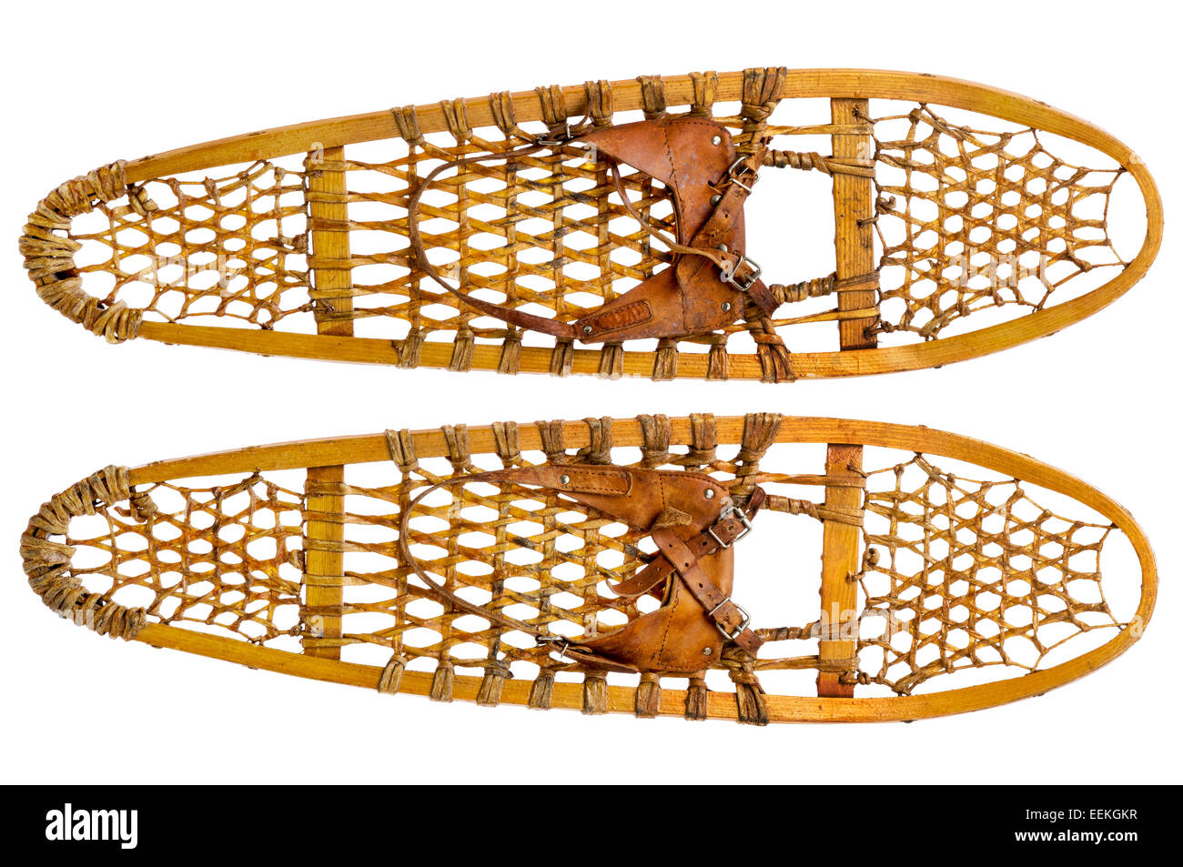 a pair of vintage wooden Bear Paw snowshoes with leather binding isolated on white Stock Photo