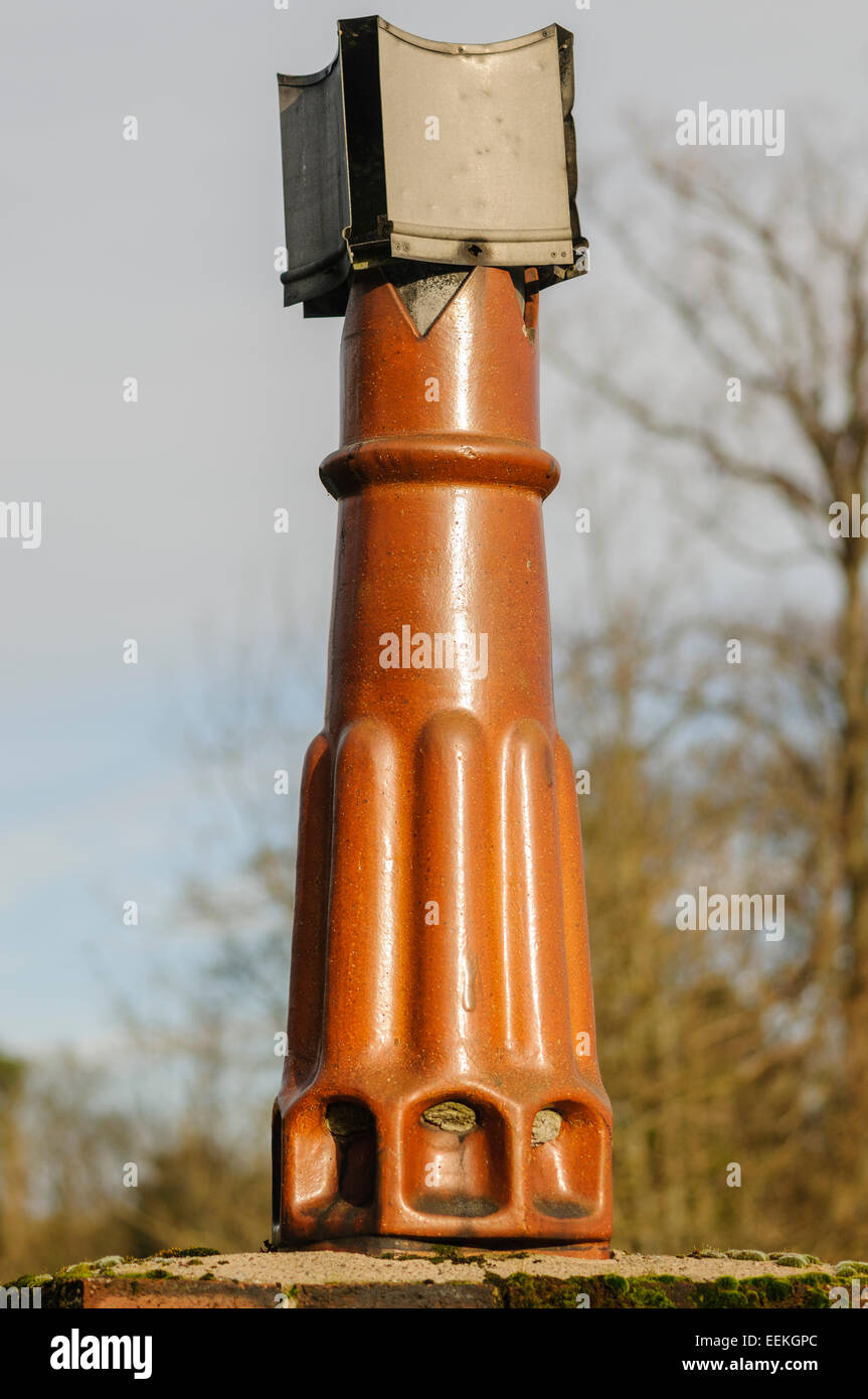 Cowling (to prevent down draughts) on an old chimneypot Stock Photo