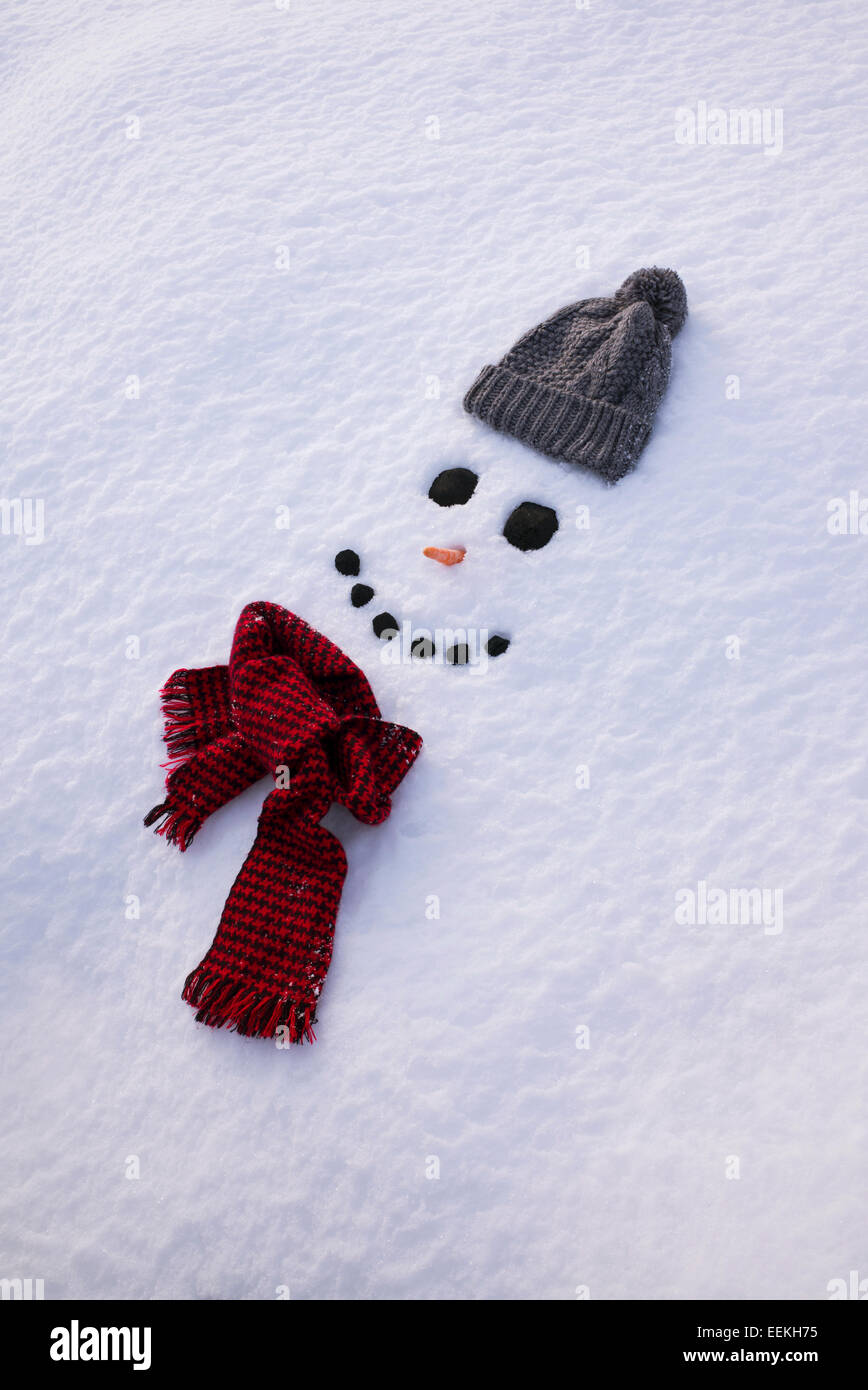 Smiling happy snowman face in snow Stock Photo