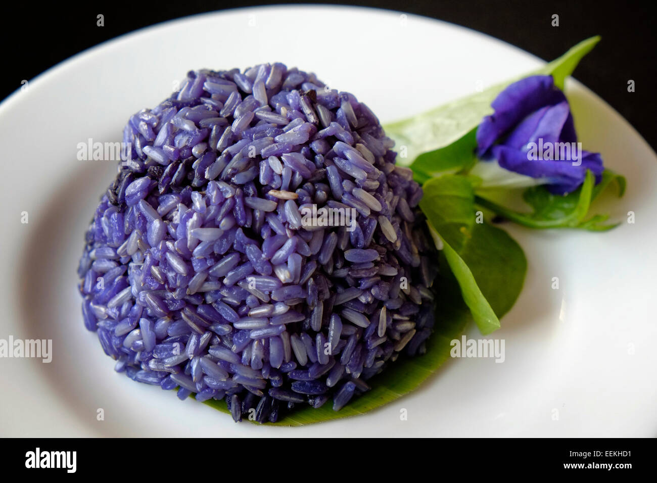 A dish of purple rice decorated with a flower which was used to dye the