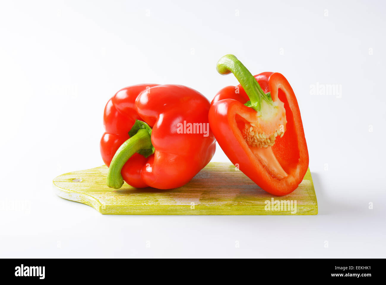 Red bell peppers on cutting board Stock Photo - Alamy