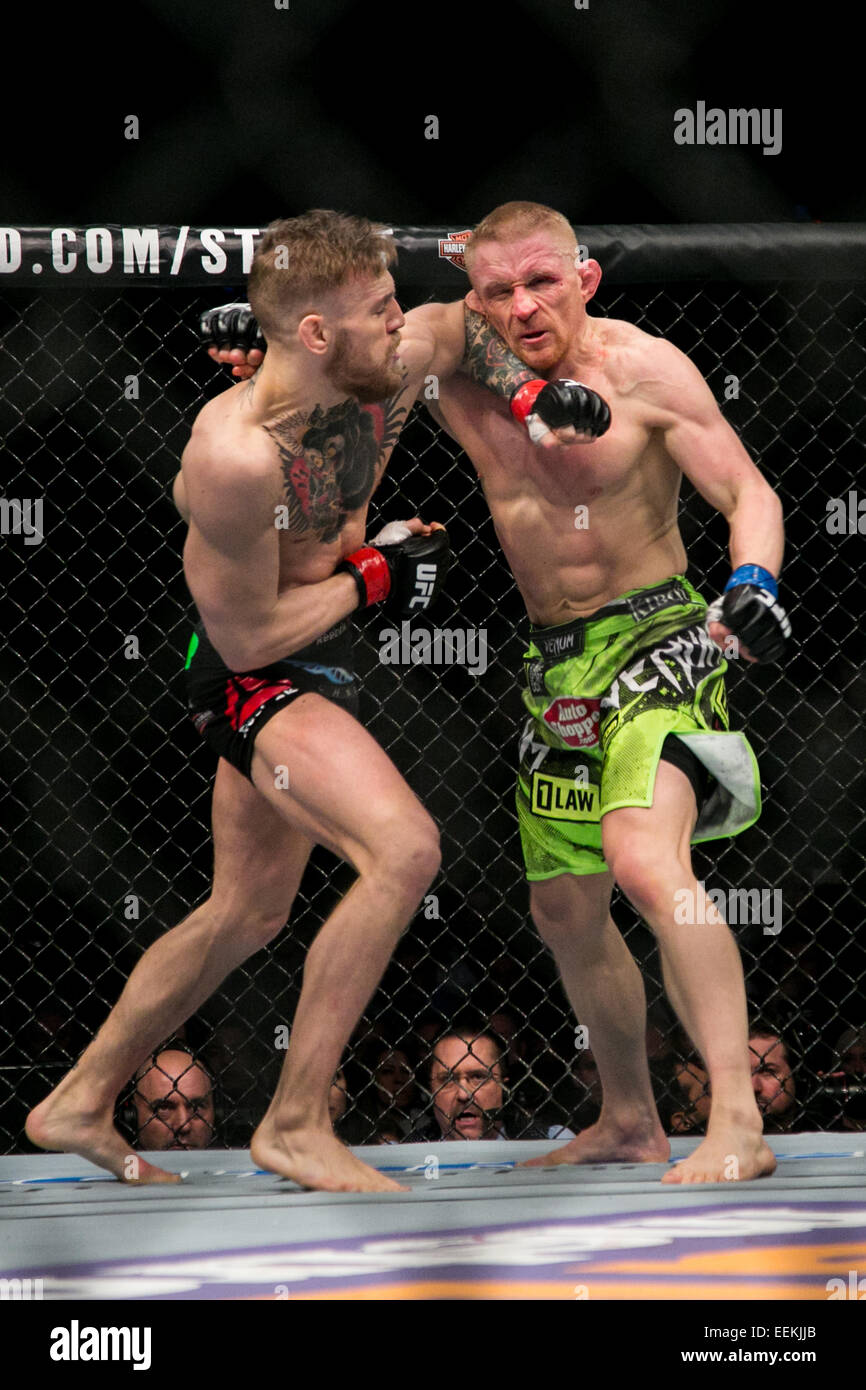 Boston, Mass. 19th Jan, 2015. 01/19/2015 -- BOSTON -- Featherweights Conor ''Notorious'' McGregor (black trunks) and Dennis Siver (green shorts) fight in their main event fight at UFC Fight Night Boston at the TD Garden on Jan. 18, 2015. McGregor won in the second round by technical knockout Credit:  Kelvin Ma/ZUMA Wire/Alamy Live News Stock Photo