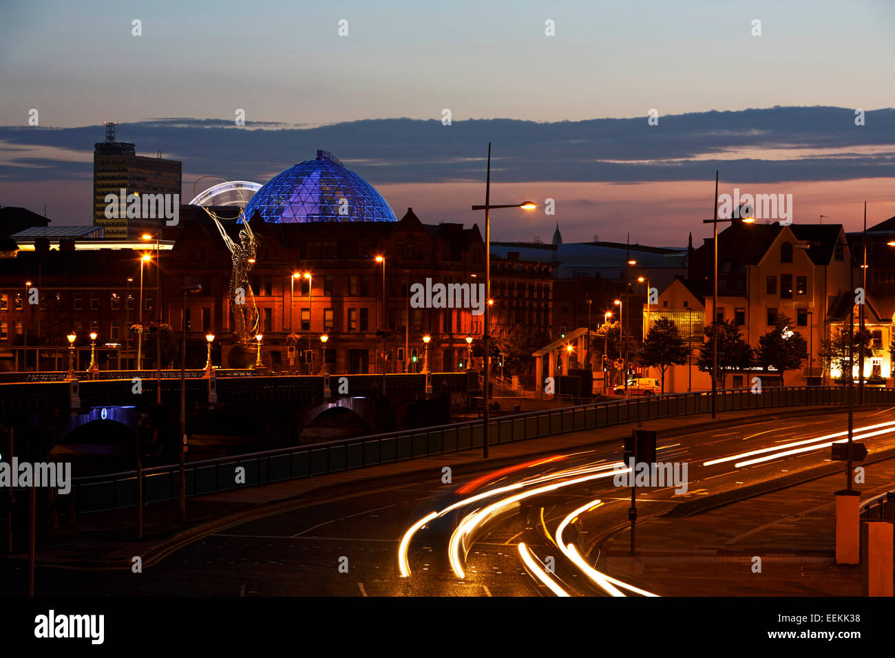 Belfast city centre skyline at dusk with light trails of traffic on
