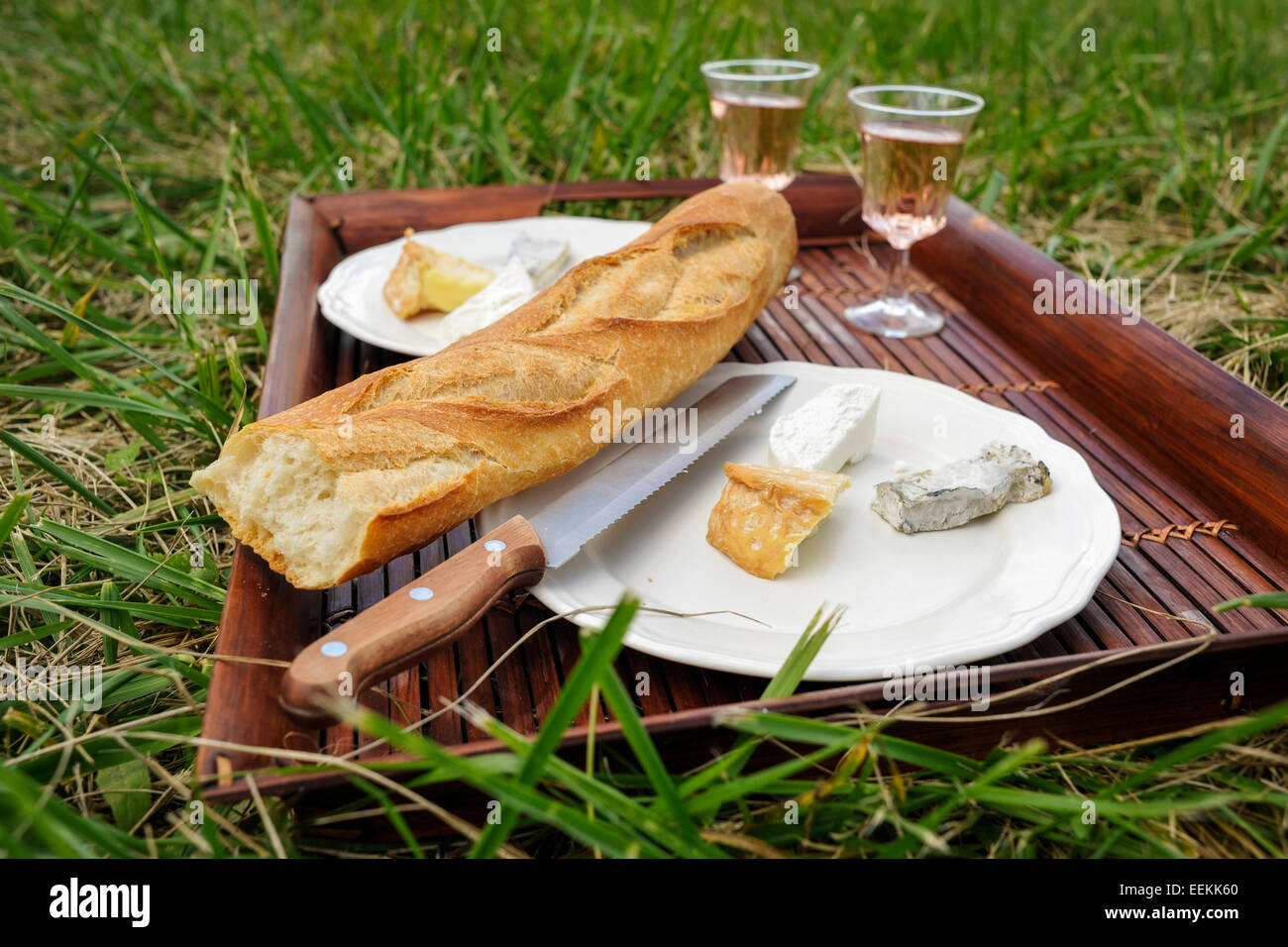 Picnic on the grass in France with bread, cheese and wine Stock Photo