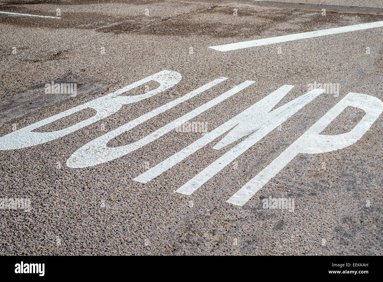 The word BUMP painted on an asphalt road. Stock Photo