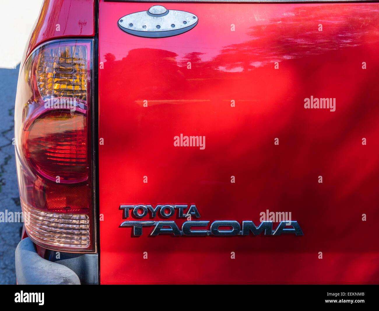 An image of a silver flying saucer icon on the back of a red pickup truck in Santa Barbara, California. Stock Photo