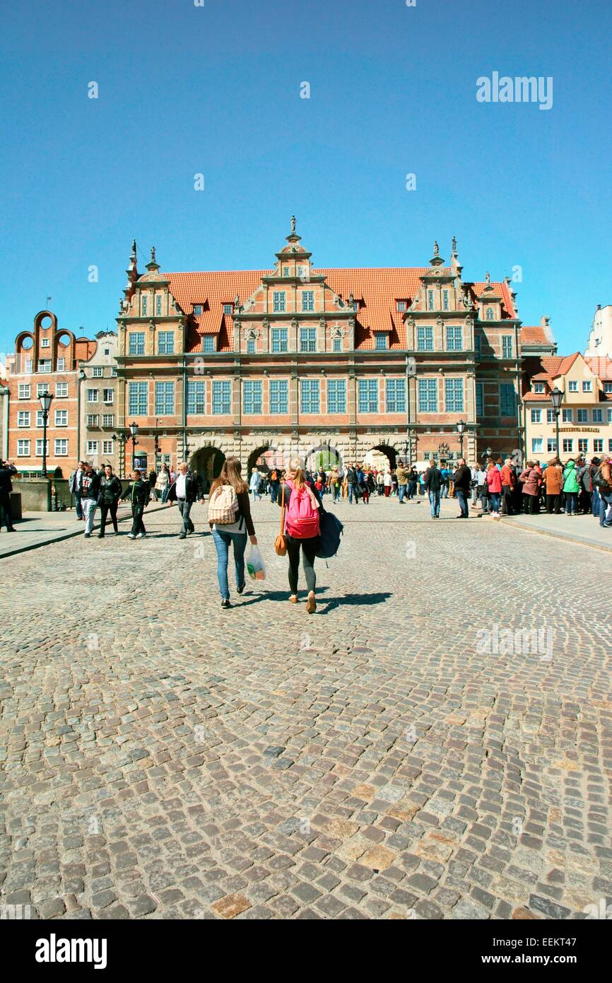 Gdansk Poland. Tourists walk across the Zielony Bridge to the 16th C Renaissance period Green Gate entrance to the Old Town Stock Photo
