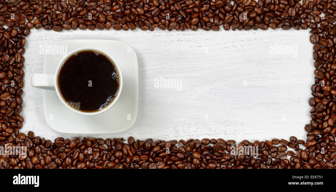 Top View Angle Of Freshly Made Dark Coffee With Roasted Beans Forming Even Border On White Wooden Table Top View Angle Of Freshly Made Dark Coffee With Roasted Beans Forming Even Border On White Wooden Table