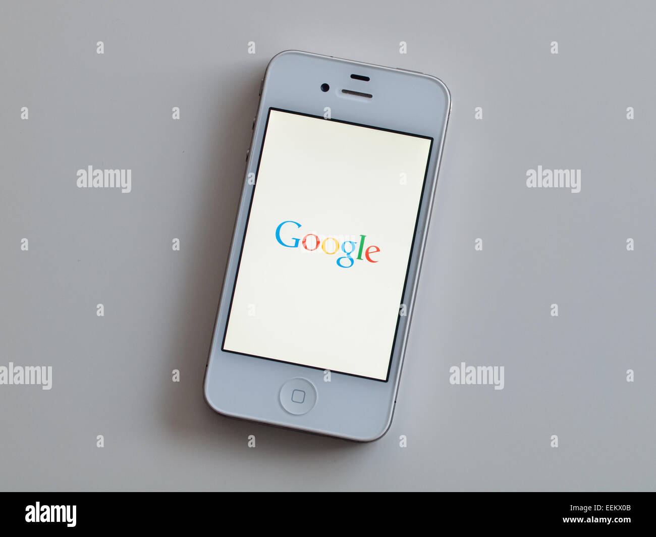 A view of the homescreen of the Google Search app on a white Apple iPhone 4. Stock Photo