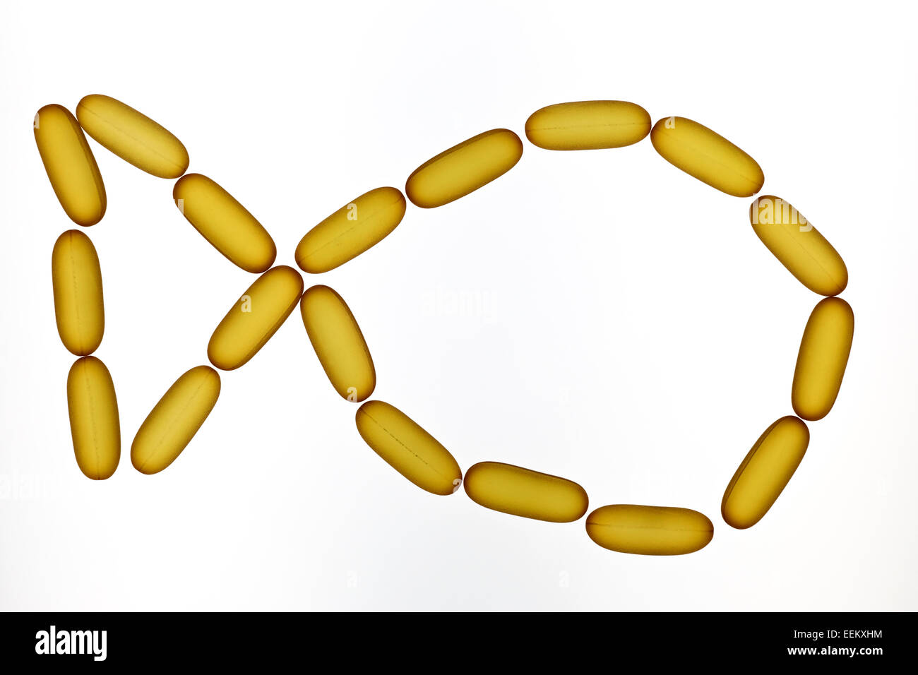 Fish oil capsules on white background in the shape of a fish. Stock Photo