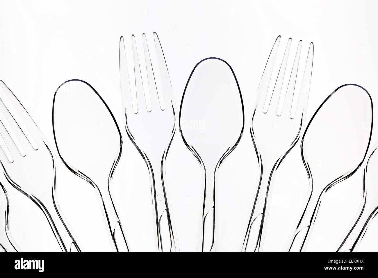 Row of clear plastic disposable spoons and forks Stock Photo Alamy