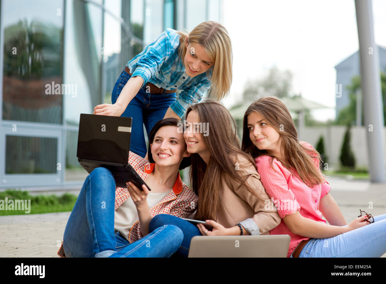 Young and happy girlfriends or classmates having fun at the School or University break. Stock Photo