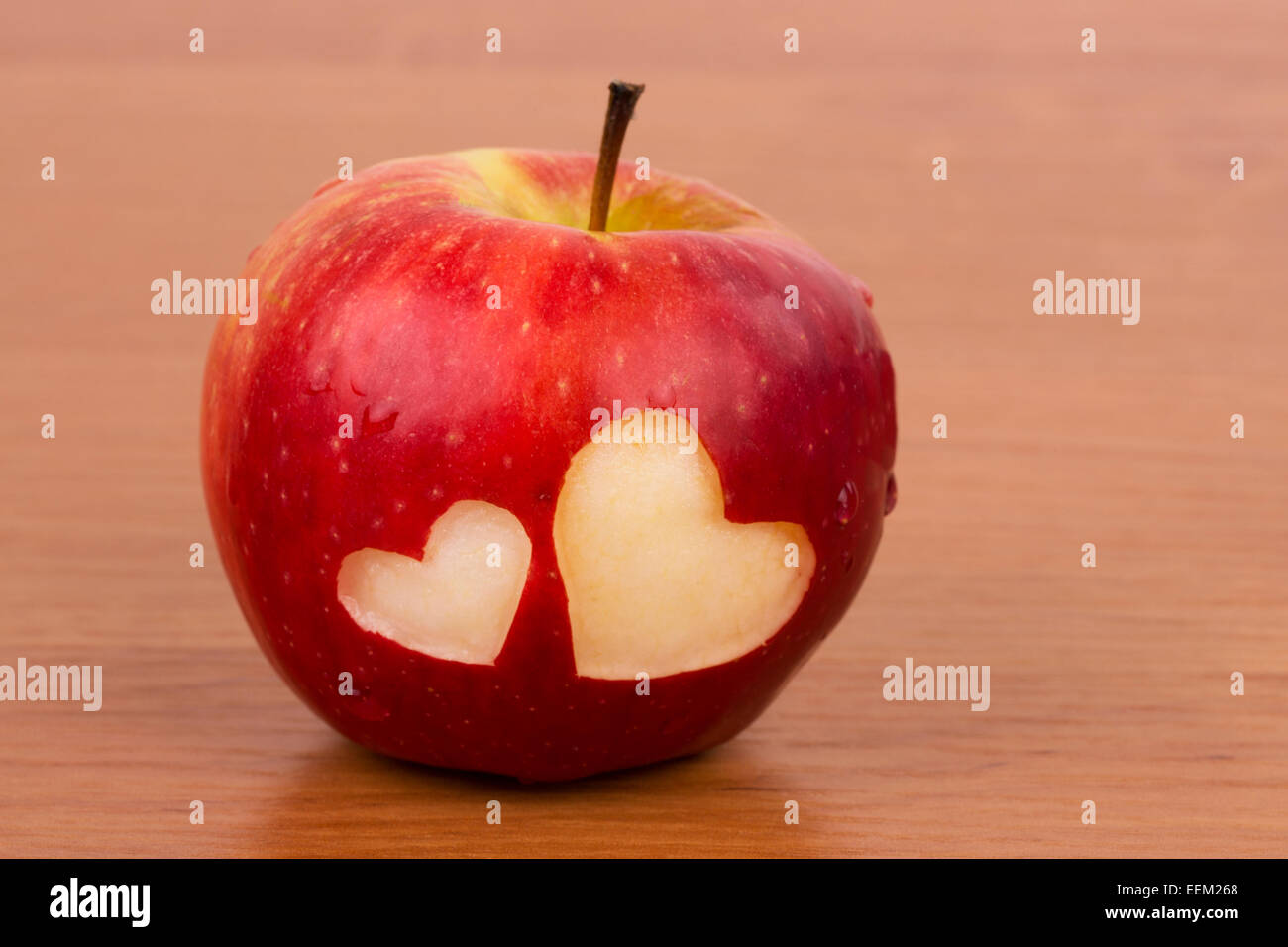 Two hearts on the fresh apple, a Valentines Day theme Stock Photo