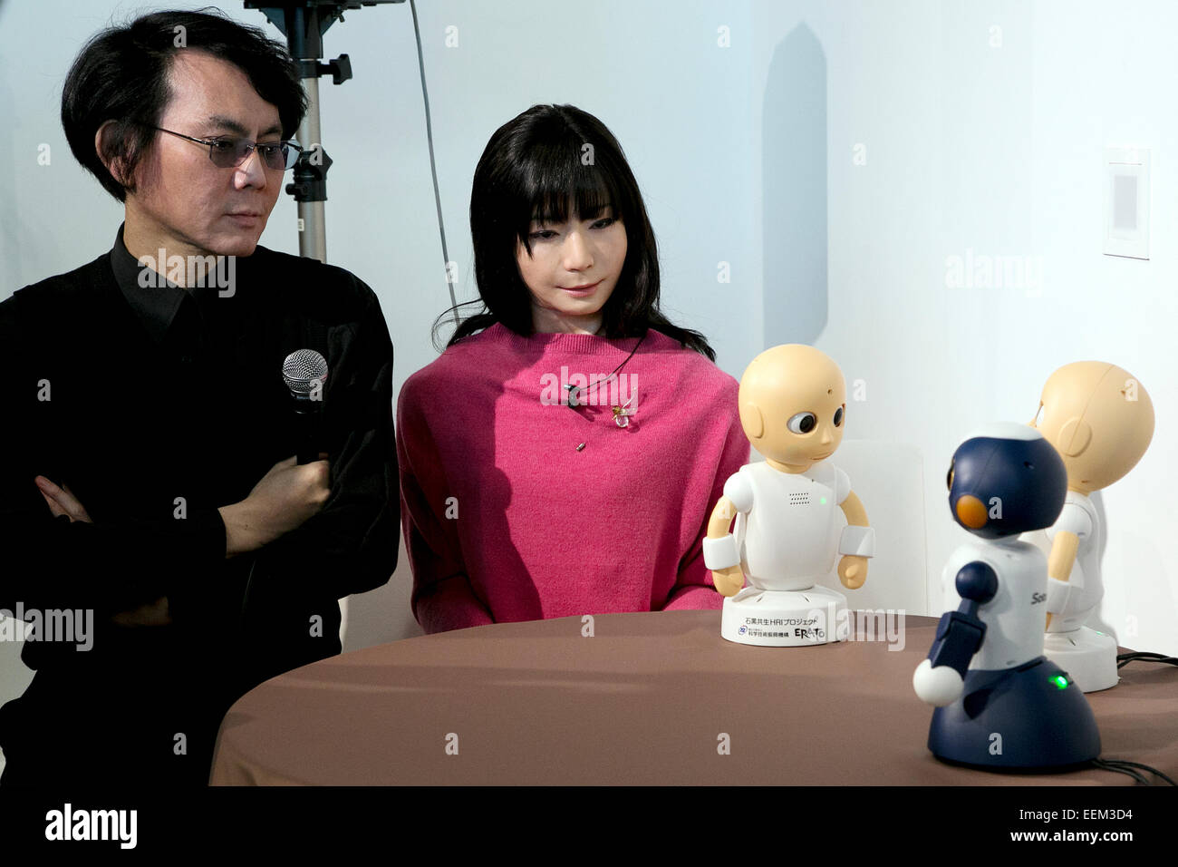 Tokyo, Japan. 20th Jan, 2015. Hiroshi Ishiguro,  Hiroshi Ishiguro professor of Osaka University speaks with CommU and Sota robots during a press conference at the National Museum of Emerging Science and Innovation Miraikan. The robots CommU and Sota can interact with humans and other robots in normal life conversation. According to profesor Ishiguro the robots can to speak, answer and ask multiple questions in Japanese and English, which can help users to learn other languages. Credit:  Rodrigo Reyes Marin/AFLO/Alamy Live News Stock Photo