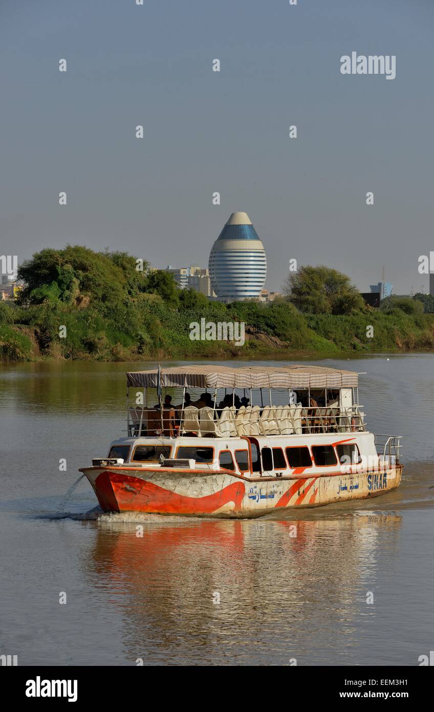 Sightseeing boat on the Nile, behind the futuristic Corinthia Hotel, Kharthoum, Sudan Stock Photo