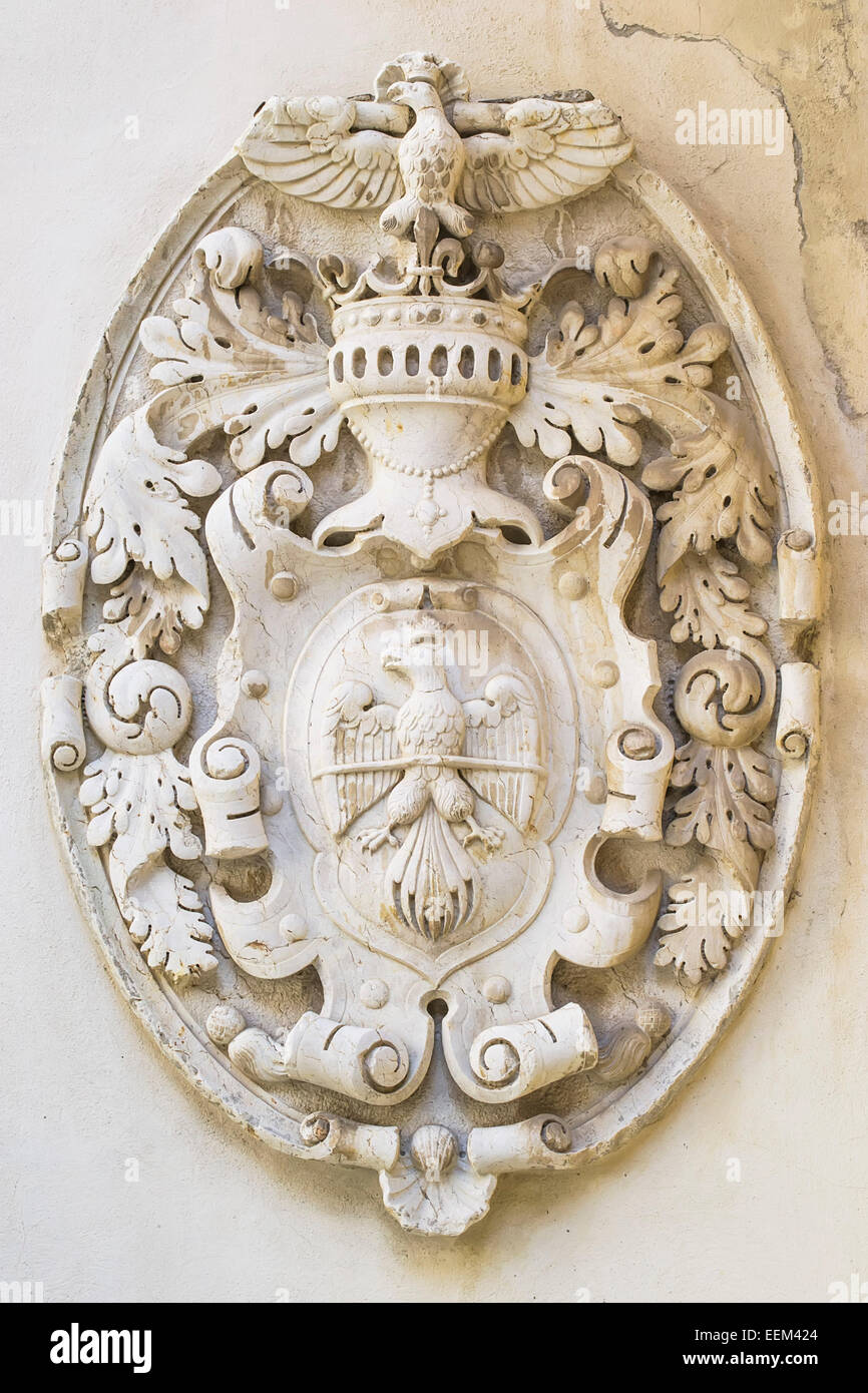 Emblem with royal symbols in bas-relief on a wall Stock Photo