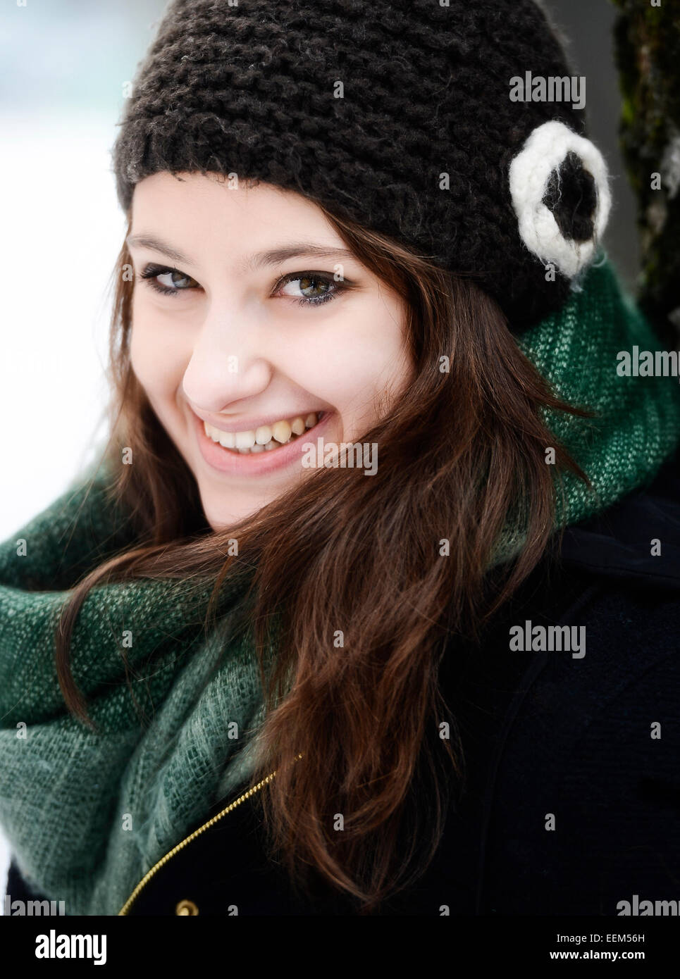 Smiling young woman wearing hat and scarf in winter, portrait Stock Photo