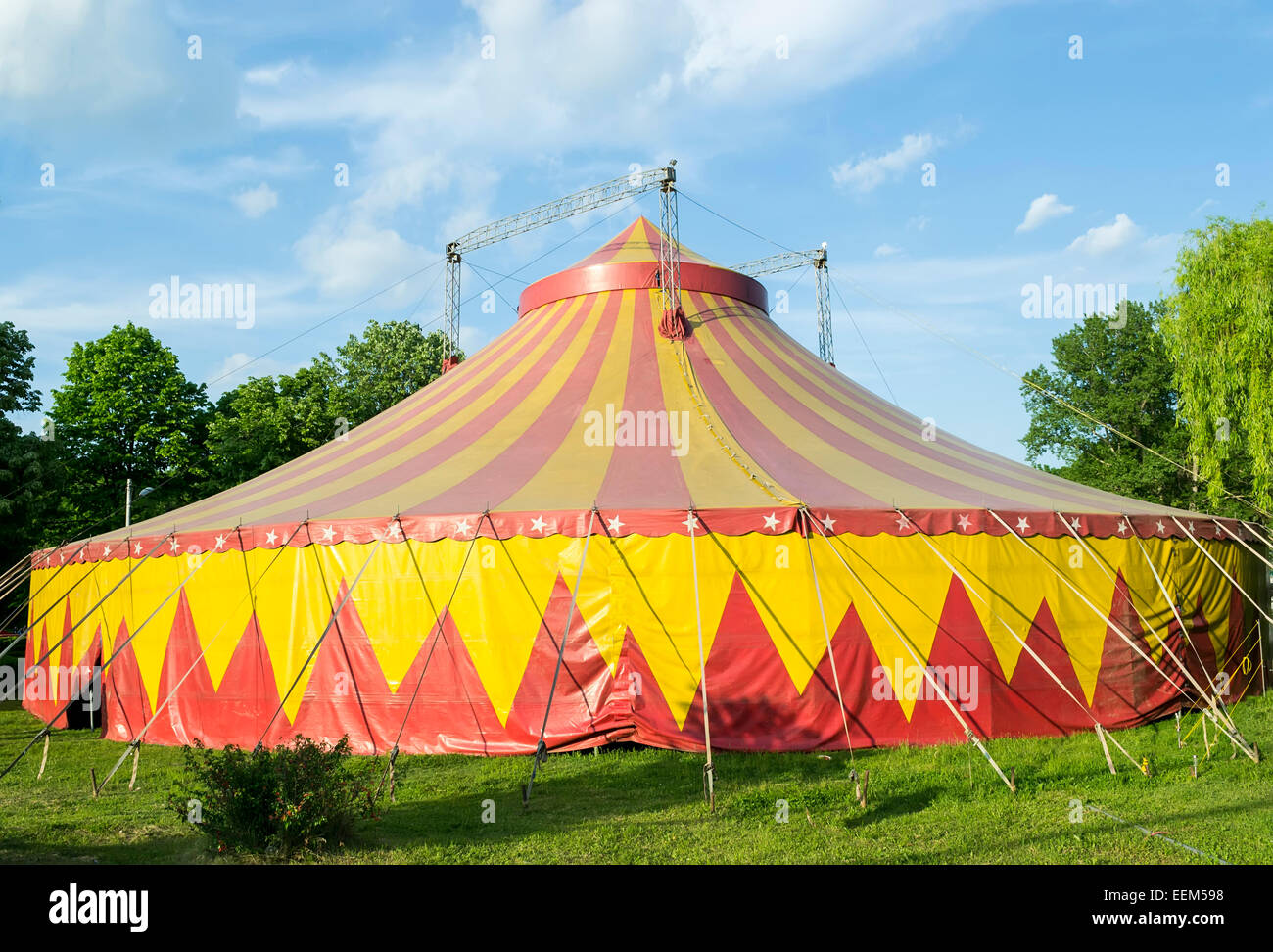 Circus tent in red and yellow colors installed for representations in a park Stock Photo