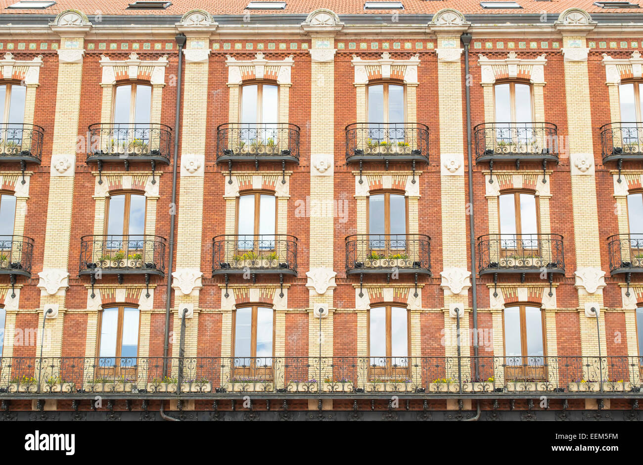 Apartment building facade with rows of balconies in European style Stock Photo