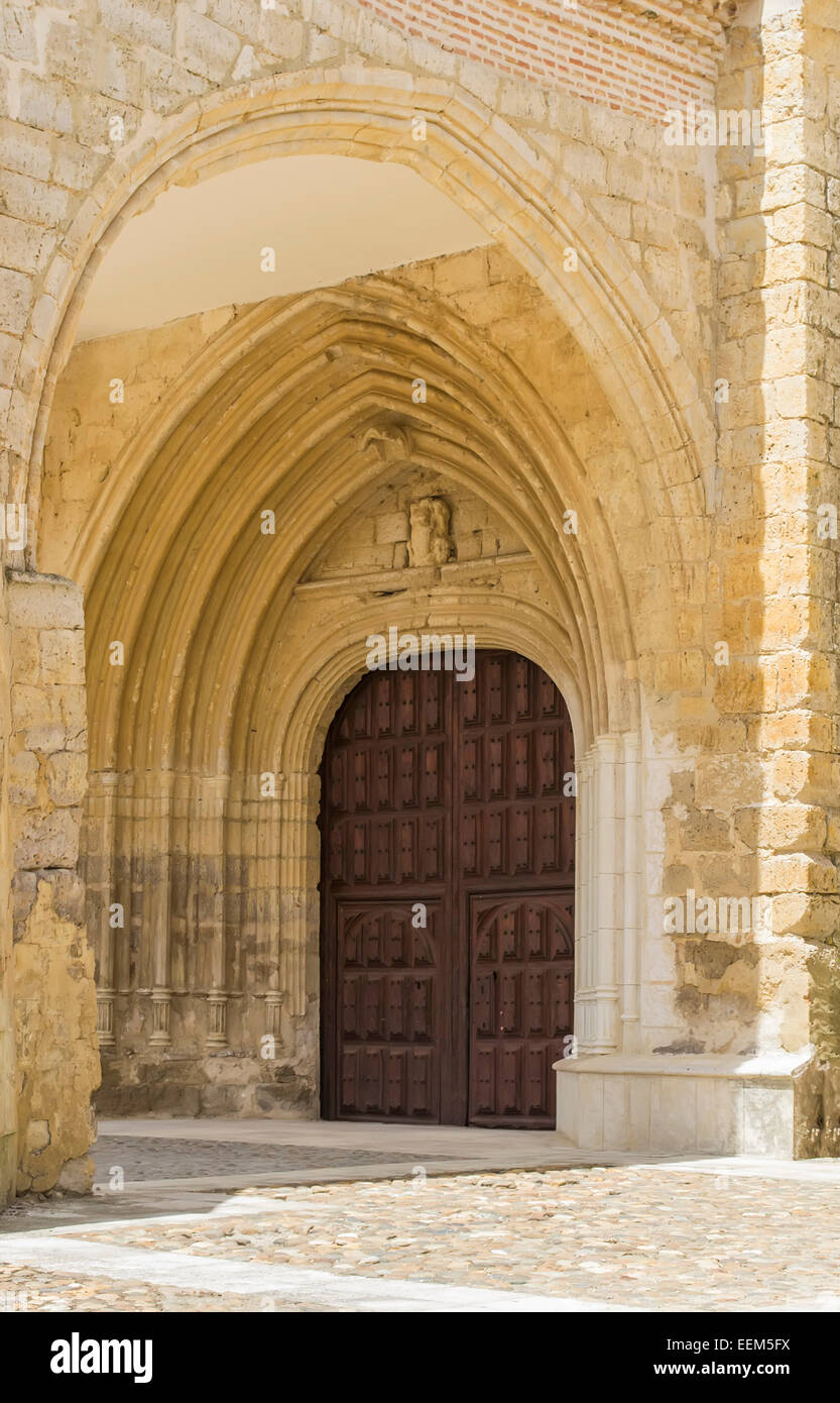 Religious edifice entrance door decorated with multiple stone arcade above it Stock Photo