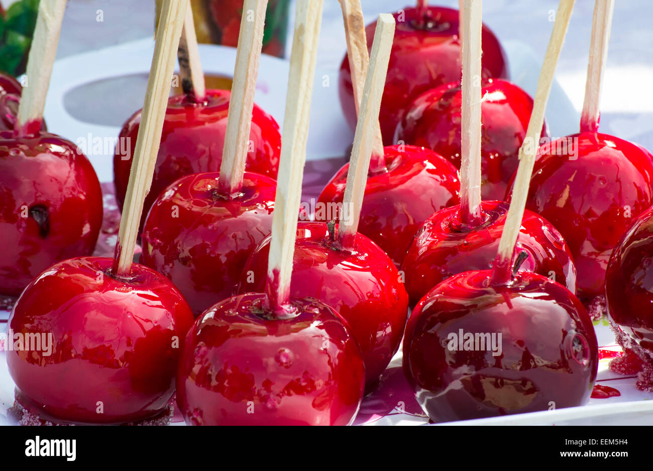 Dozen of delicious glazed apples covered in intense red sugar coating Stock Photo