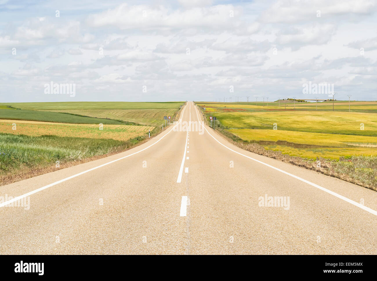 Open road through a plain that never seems to end Stock Photo