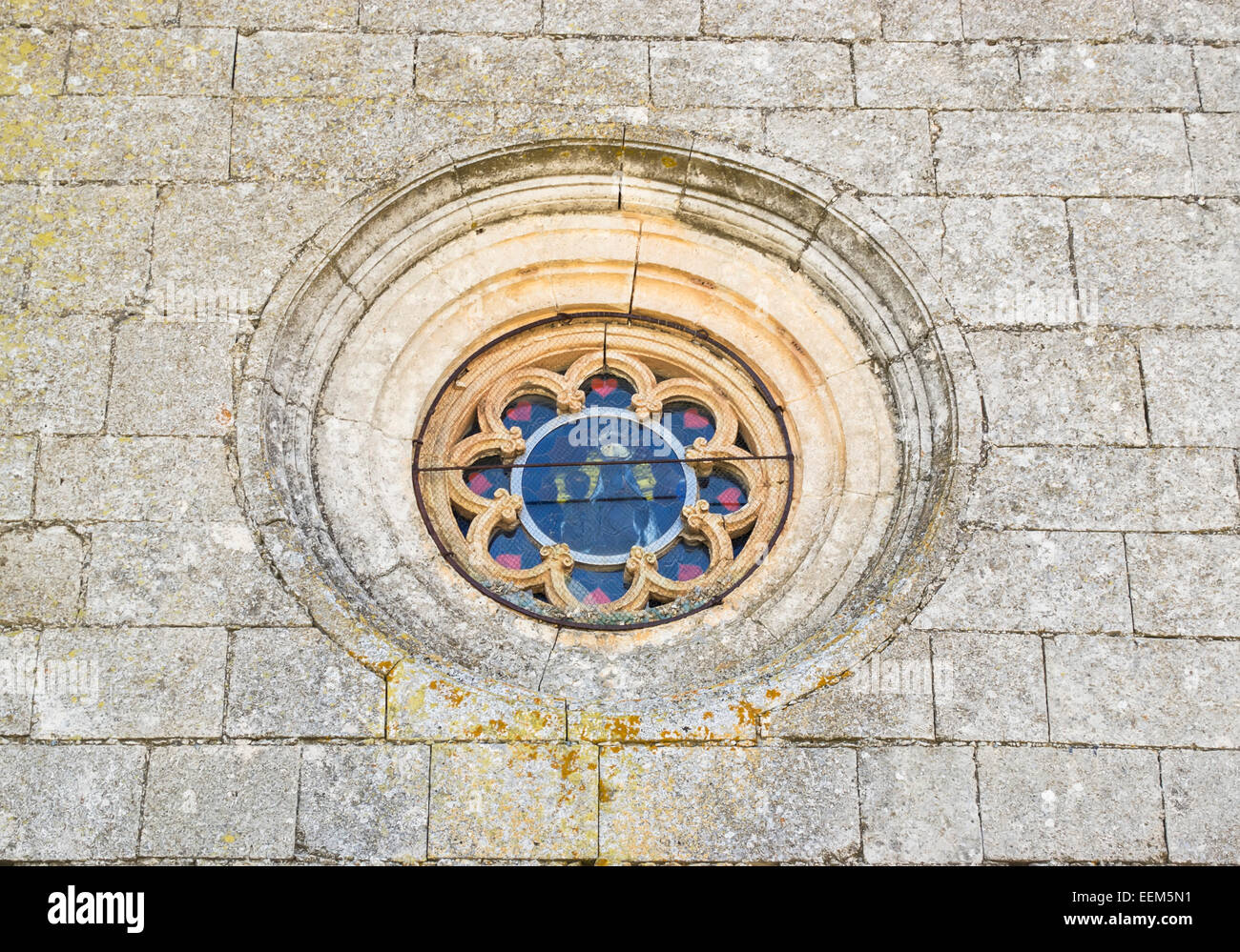 Gothic round window of a religious edifice with stained glass and stone floral pattern Stock Photo