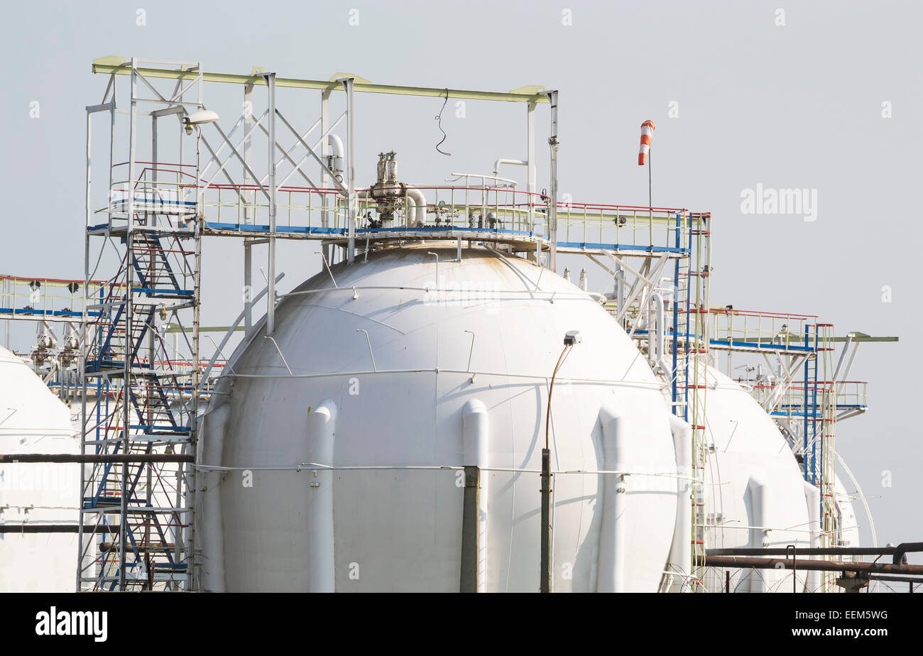 Spherical reservoirs containing liquefied natural gas on a refinery platform Stock Photo