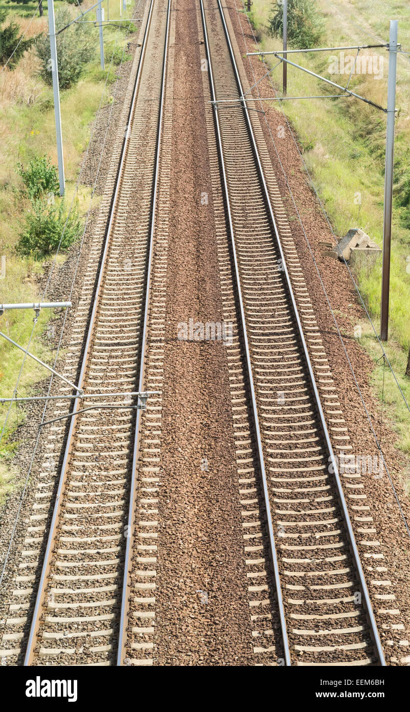 Railroad tracks with no trains on it of an electrified transportation route Stock Photo