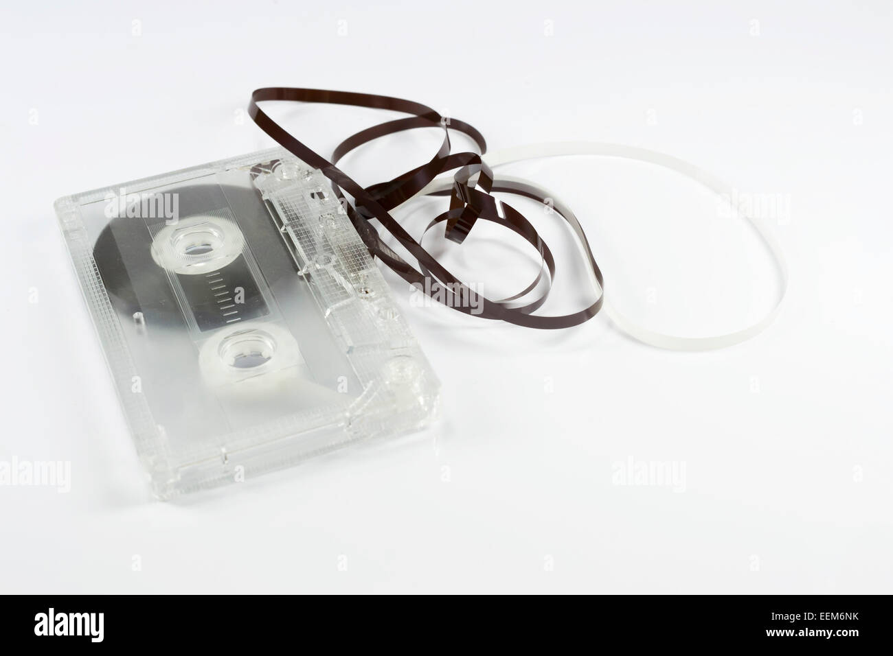 Transparent plastic audio cassette with the tape loose and